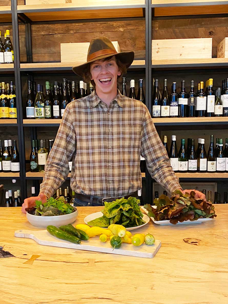 On of our local famers displaying local lettuce, squash and zucchini.