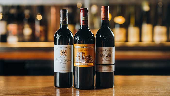 Three premium wines displayed on the bar