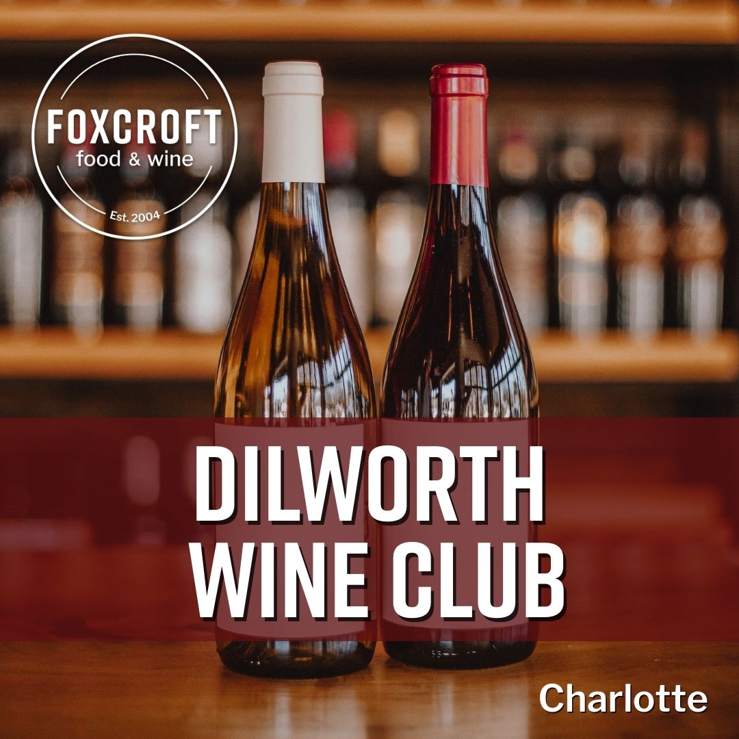 Two wine bottles on a bar with 'Foxcroft food & wine' and 'Dilworth Wine Club Charlotte' text.