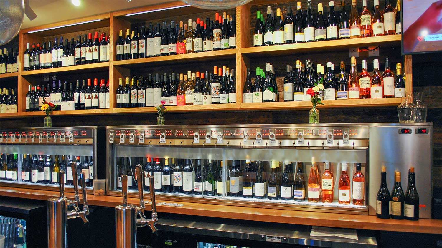 Wines displayed on shelves above our temperature controlled by-the-glass station.