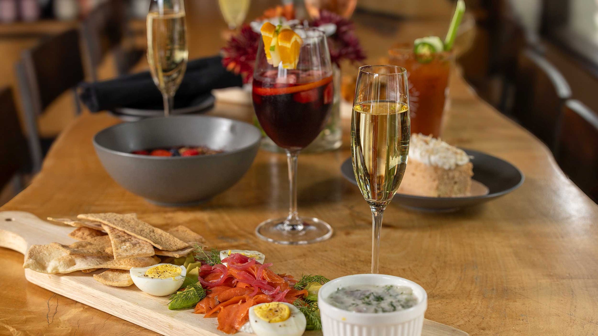 Brunch table with Salmon and eggs, sparkling wine, and sangria. 