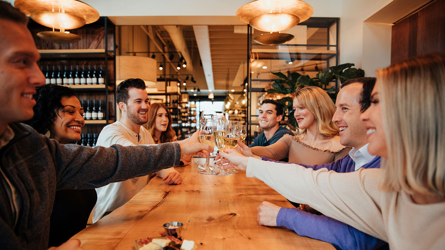 Group of guests cheersing with white wine