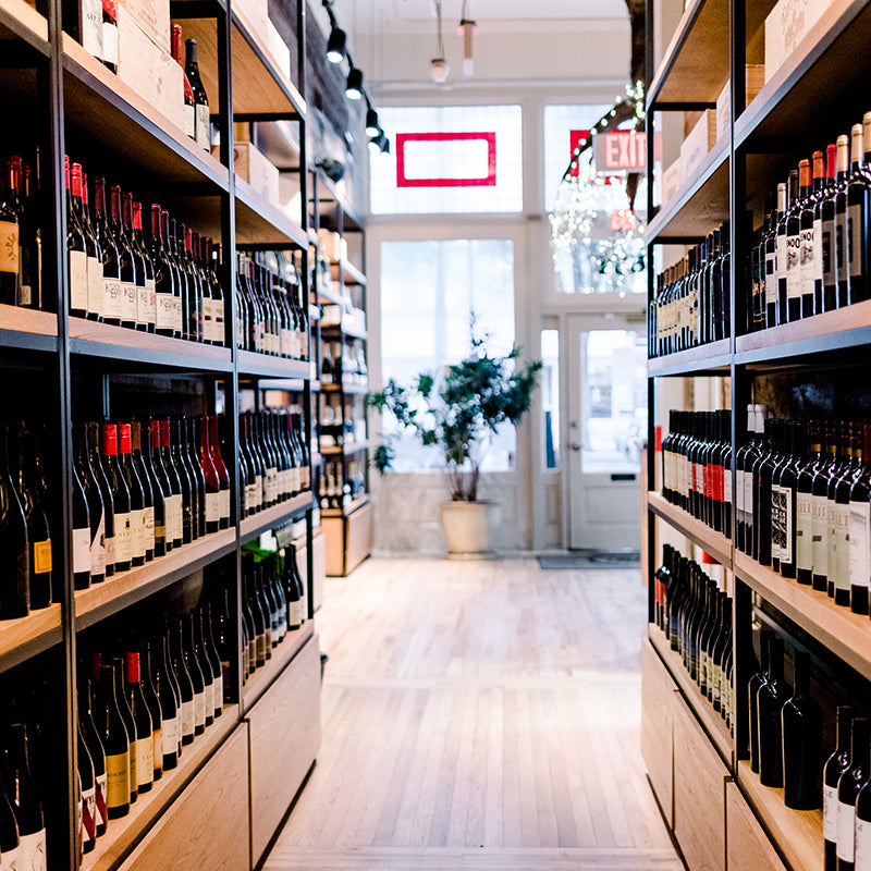 Tall shelves of wine at Foxcroft Greenville.