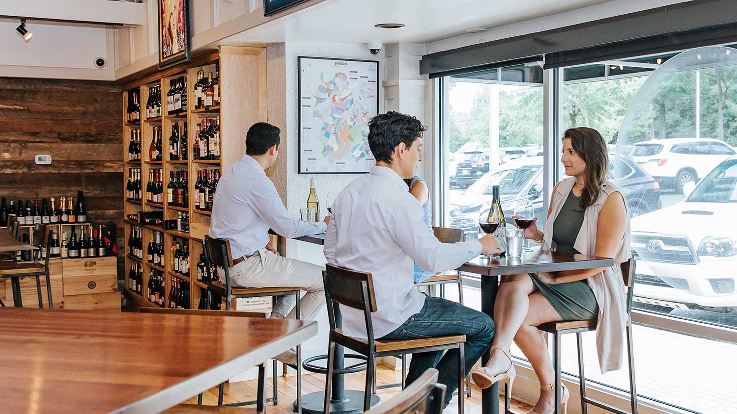 Guests enjoying wine at bar top tables at Foxcroft SouthPark.